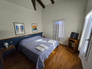 a small bedroom with a bed and a television at Residence Al Bacareto in Mogliano Veneto