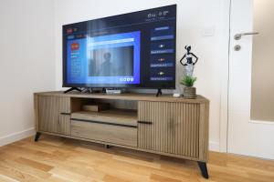 a television on a wooden stand in a room at Central Rooftop Apartment in Trebinje