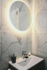 a bathroom with a sink and a mirror at Liebe 16 luxurious stay in Volos