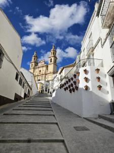 a building with two towers on the side of a street at Casa Borete in Olvera