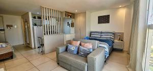 a room with a couch and a bed and a chair at Ponta de Campina: VISTA MAR, Piscina e Conforto in Ilha da Restinga +40 photos