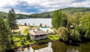an aerial view of a house on the shore of a lake at SpaHaus #128 in Lac-Superieur