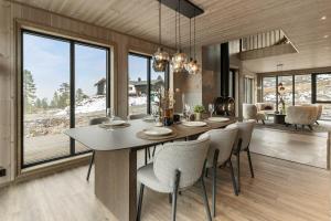 a dining room with a large table and chairs at Hydla Mountain Lodge in Stryn