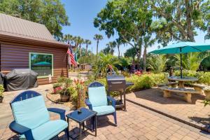 a patio with chairs and a grill and a picnic table at Cabin with Boat Launch and Pool Access in Okeechobee in Okeechobee