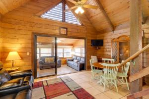 a dining room and living room with a vaulted ceiling at Cabin with Boat Launch and Pool Access in Okeechobee in Okeechobee