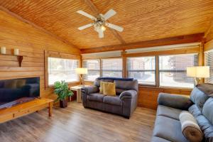 a living room with two couches and a ceiling fan at Cabin with Boat Launch and Pool Access in Okeechobee in Okeechobee