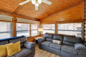 a living room with two couches and a ceiling fan at Cabin with Boat Launch and Pool Access in Okeechobee in Okeechobee