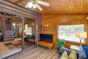 a living room with wooden walls and a ceiling at Cabin with Boat Launch and Pool Access in Okeechobee in Okeechobee