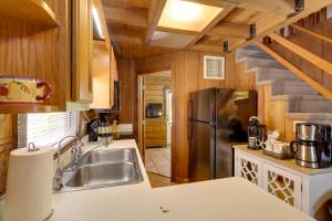a kitchen with a sink and a refrigerator at Cabin with Boat Launch and Pool Access in Okeechobee in Okeechobee