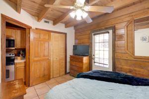 a bedroom with a bed and a ceiling fan at Cabin with Boat Launch and Pool Access in Okeechobee in Okeechobee