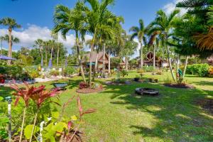 a resort yard with palm trees and a grill at Cabin with Boat Launch and Pool Access in Okeechobee in Okeechobee