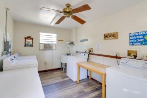 a room with three washing machines and a ceiling fan at Cabin with Boat Launch and Pool Access in Okeechobee in Okeechobee