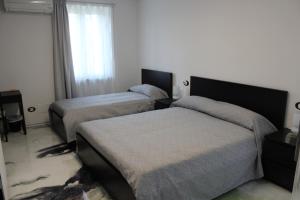 a bedroom with two beds and a window at Follow Me B&B in San Salvo