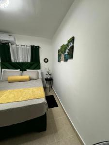 a bedroom with a bed with a yellow blanket at Sweet dreams Tropical paradise in San Isidro +49 photos