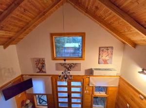 a kitchen with a chandelier hanging from the ceiling at Nordica D in Coñaripe