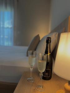 a bottle of champagne and two glasses on a table at Villa Tabaku in Berat