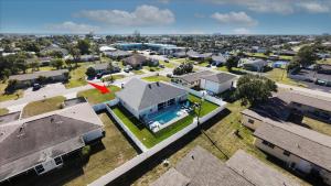 an aerial view of a house with a pool at 5 Star, Twin Home, Heated Pool Located D-town Cape in Cape Coral