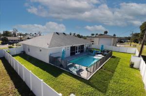a house with a swimming pool in the yard at 5 Star, Twin Home, Heated Pool Located D-town Cape in Cape Coral