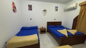 a bedroom with two beds in a room at Sina house in Dahab