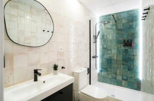 a bathroom with a sink and a shower and a mirror at Nomad Malaga - Airport III in Málaga +16 photos