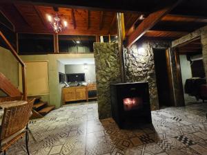 a living room with a wood stove in a room at La Azotea cabañas & suites in La Cumbrecita
