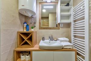 a bathroom with a sink and a mirror at Gorski Elegance Apartments Premium in Zlatibor +16 photos