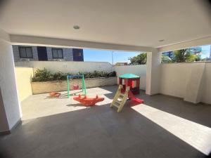 a room with a play area with a playground at lindo 3qts AR Churrasqueira Piscina Centro Forte Cabo Frio in Cabo Frio