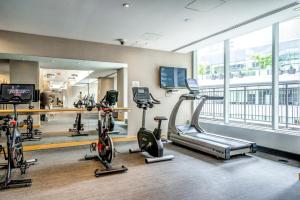 a gym with bikes and treadmills in a building at Spacious Condo Next To CN Tower in Toronto