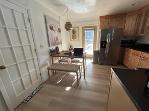 a kitchen with a table and a refrigerator at COH0957 - Bella Ari home in South Lake Tahoe