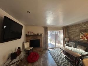a living room with a couch and a television at HCC0410 - Heavenly Hideaway in South Lake Tahoe