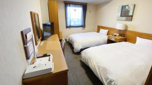 Llit o llits en una habitació de Hotel Route-Inn Yokkaichi