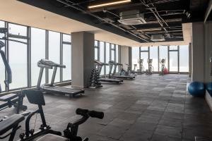 a gym with a row of treadmills and machines at Brand NEW! Ocean front,City 360Views 26FL,FREE Airport pick up by IMZ in Cartagena de Indias