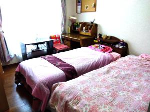 Postel nebo postele na pokoji v ubytování OSO Homestay