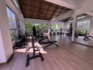 a gym with treadmills and exercise equipment in a room at Samaria Top Penthouse Frente al Mar in Gaira