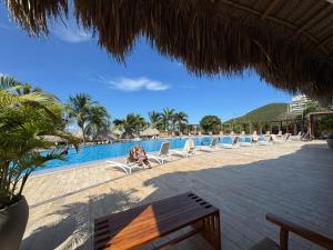 a view of a pool at a resort with chairs at Samaria Top Penthouse Frente al Mar in Gaira