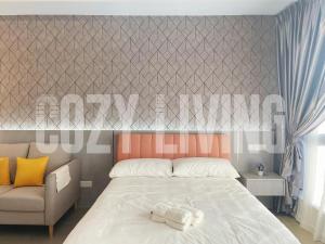 a bedroom with a bed and a chair at Mossaz in Petaling Jaya +47 photos