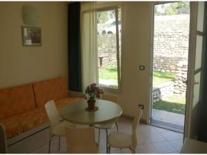 a living room with a table and chairs and a couch at Studio für 4 Personen in Imperia in Imperia