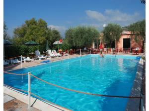 a large blue swimming pool with a person in it at Studio für 4 Personen in Imperia in Imperia