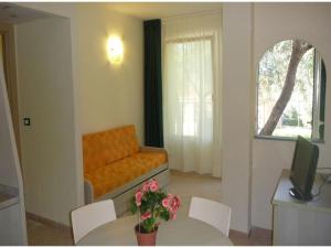 a living room with a couch and a table with flowers at Studio für 4 Personen in Imperia in Imperia