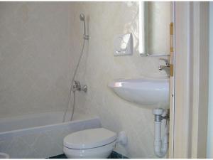 a bathroom with a toilet and a sink at Studio für 4 Personen in Imperia in Imperia +9 photos