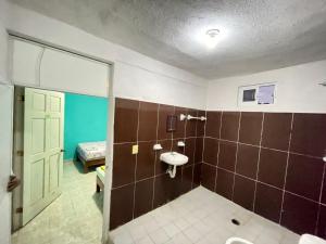 a bathroom with a sink and a toilet at Hotel Toño in Barra Vieja