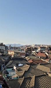 a view of roofs of buildings in a city at JTN House for daily rent in Seoul Oktabang in Seoul