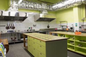 a large kitchen with green cabinets and a counter top at Abraham Tel Aviv in Tel Aviv