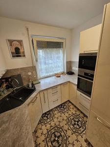 a kitchen with a sink and a stove top oven at 3 Room Apartmend by Frankfurt in Bad Vilbel