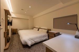 a hotel room with a bed and a projection screen at Tabi and Nagasaki Grand Open!! 2025 in May in Nagasaki