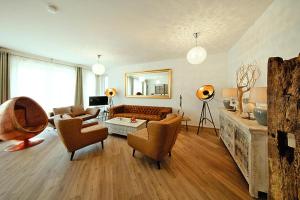 a living room with a couch and chairs and a table at Apartment für 3 Personen in Strausberg in Strausberg
