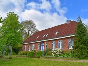 a red brick house with a red roof at Apartment für 3 in Schulenbrook in Metelsdorf