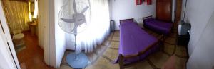 a room with two beds and a fan at Ensueñoneco in Necochea