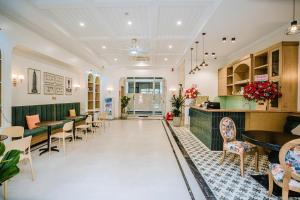 a lobby of a restaurant with tables and chairs at Samson Soleil Hotel in Sầm Sơn