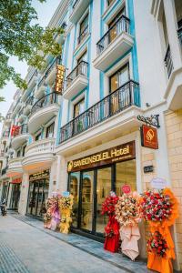 a store on a street in front of a building at Samson Soleil Hotel in Sầm Sơn